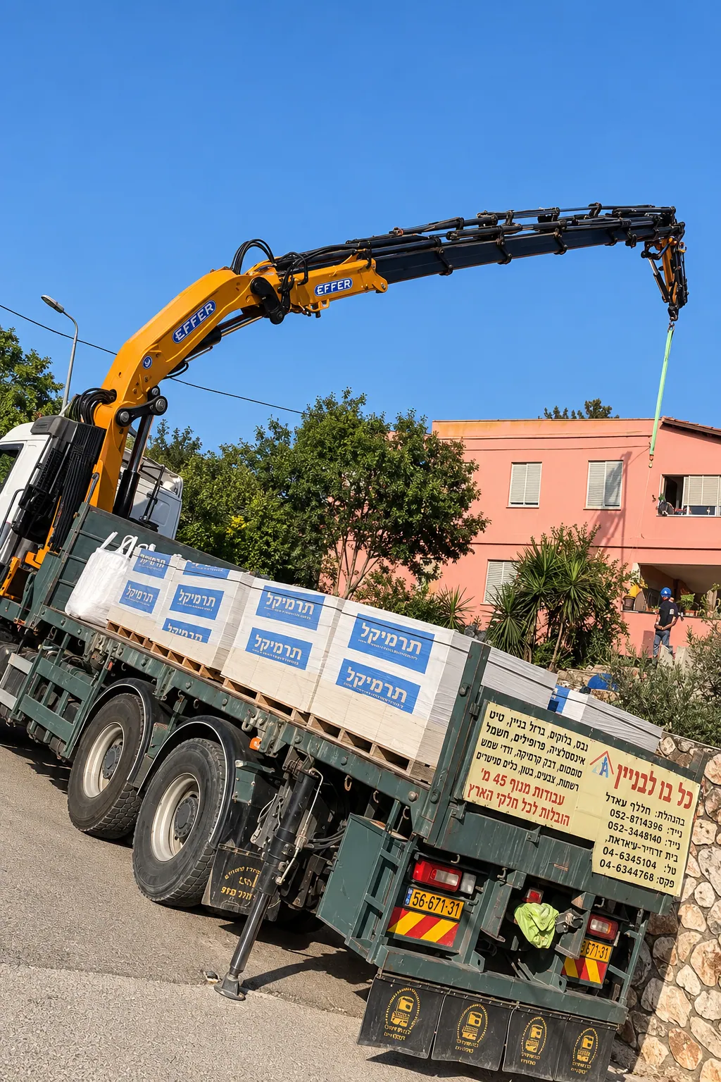 Our crane truck unloading pallets of tile adhesive