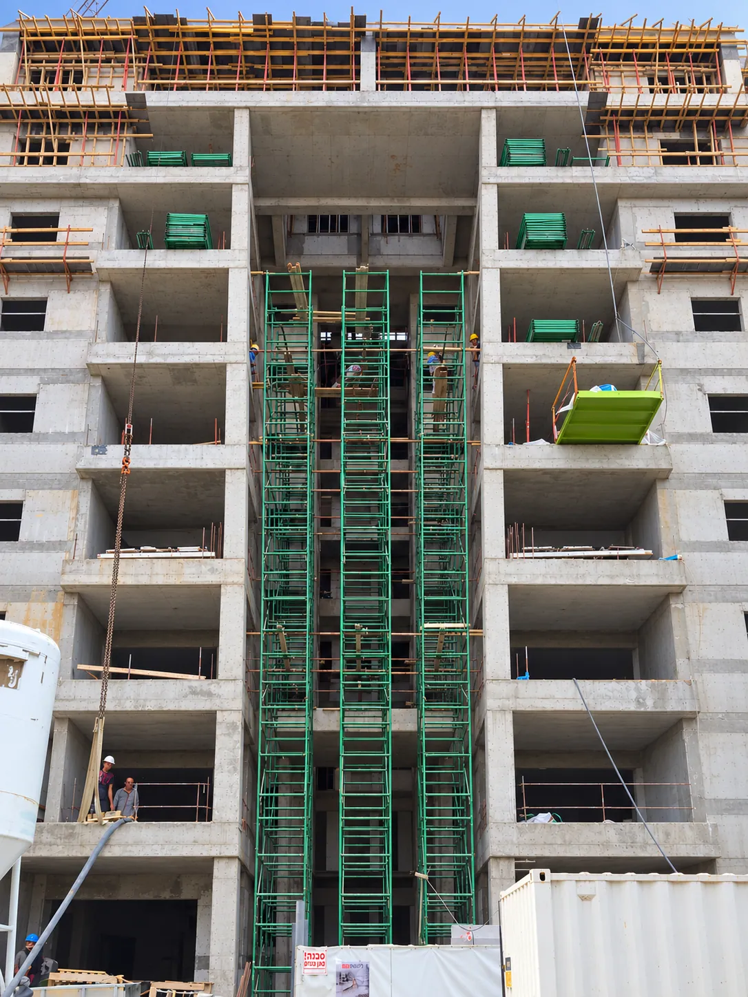 A concrete frame under construction with scaffolding
